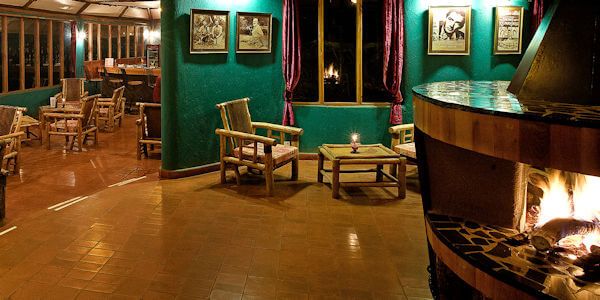 Nagenieten in de lounge met open haard is het gezellige hart van de accommodatie. Nagenieten in de lounge met open haard is het gezellige hart van de accommodatie, accommodatie Amboseli Nationaal Park in Kenia