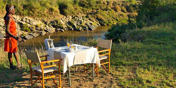 Romantisch genieten van een ontbijt op de savanne in de Masai Mara. Romantisch genieten van een ontbijt op de savanne in de Masai Mara.
